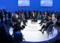 A group of people sitting on a round table discussing matters. Symbolic representation of the World Economic Forum in Riyadh.