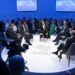 A group of people sitting on a round table discussing matters. Symbolic representation of the World Economic Forum in Riyadh.