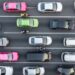 Aerial view of Dubai Traffic in a parking lot with numerous cars parked in organized rows.