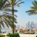 Doha skyline and traditional Qatari dhows in calm waters, framed by palm trees, symbolising Qatar’s stability, economic resilience, and strategic leadership in a volatile region.