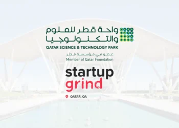 Logos of Qatar Science & Technology Park and Startup Grind Doha with QSTP campus in the background